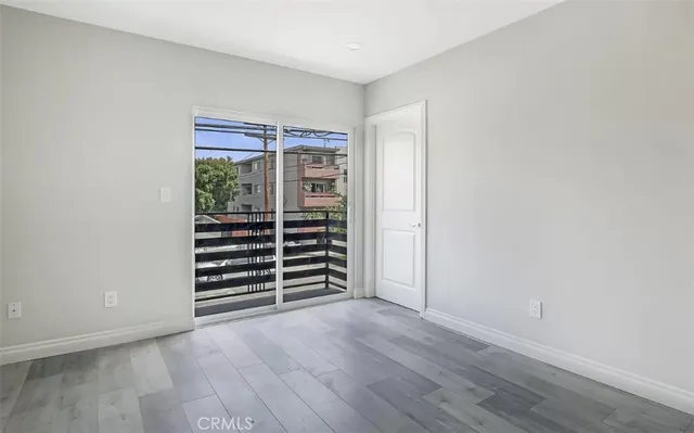 a view of wooden floor and windows in a room