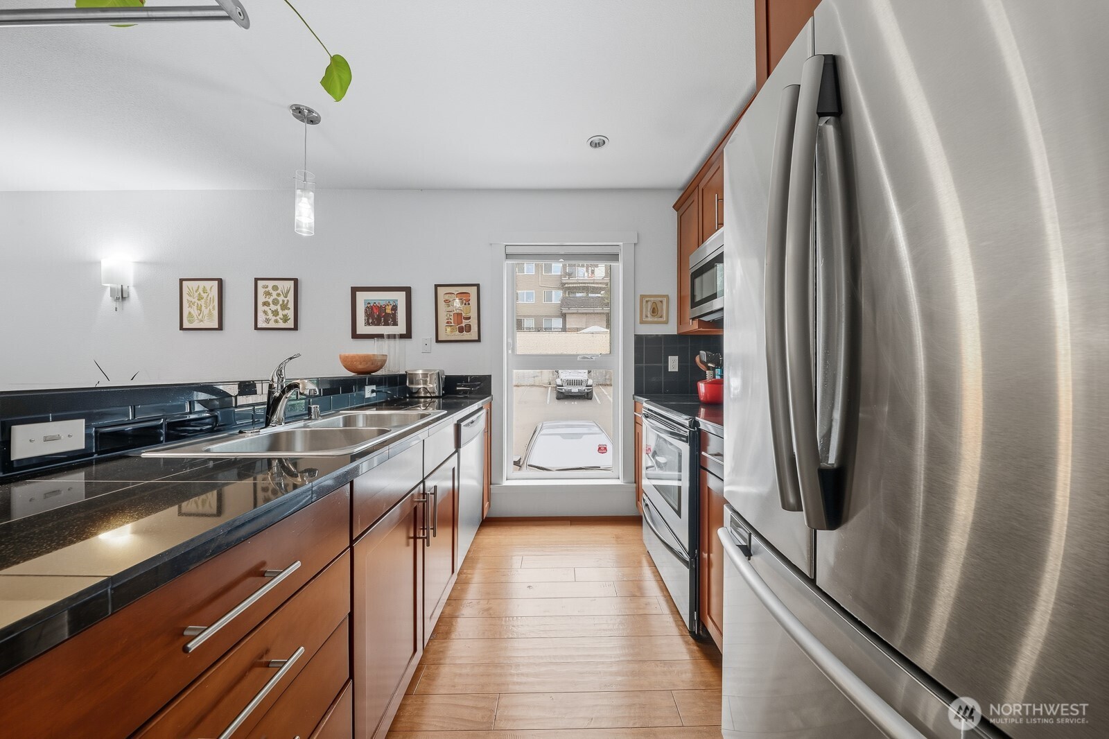 900 Summit Avenue East, Unit 303 Seattle, WA 98102 - Photo 14 of 25 a kitchen with stainless steel appliances granite countertop a refrigerator and a sink