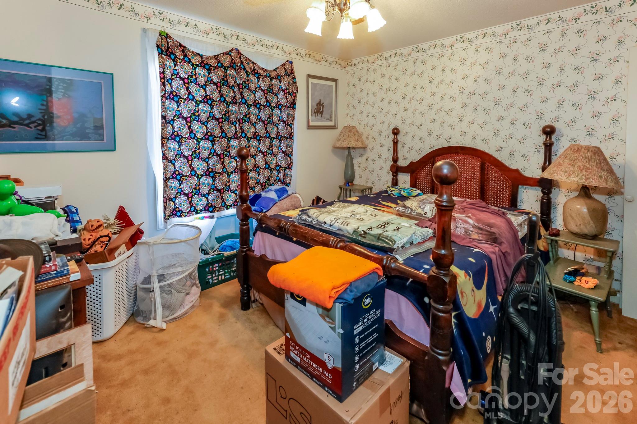 350 Morningstar Lake Road Forest City, NC 28043 - Photo 14 of 27 a bedroom with a bed and a lamp on the wall