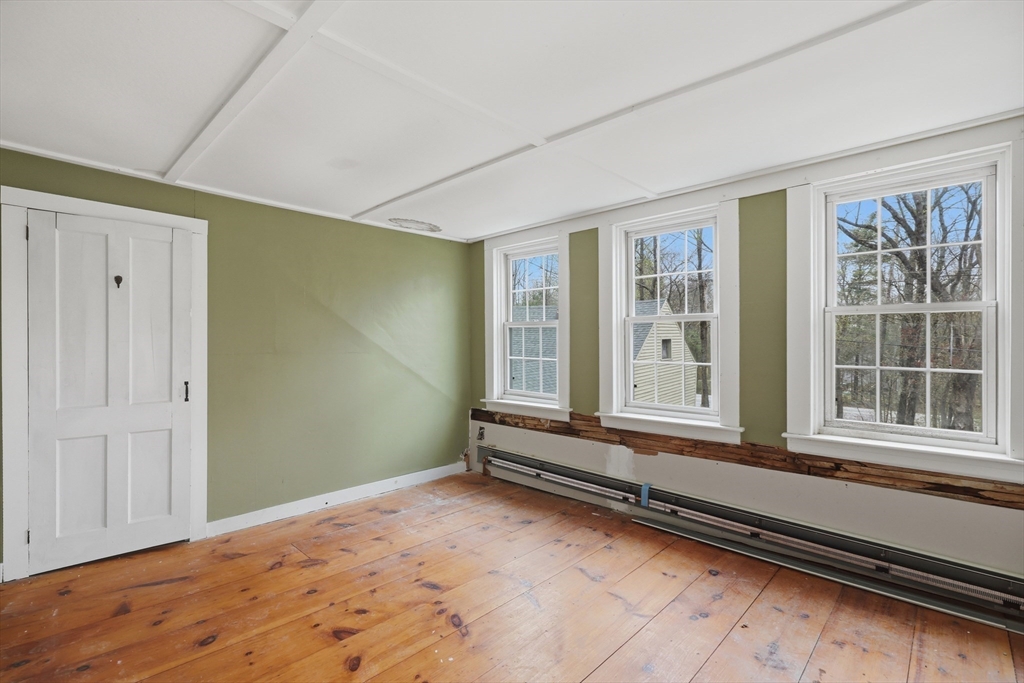 5 Gap Mountain Road Fitzwilliam, NH 03447 - Photo 16 of 31 a view of a room with wooden floor and windows