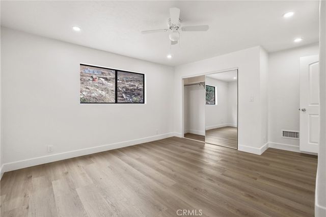 a view of a patio with couple of chairs and a potted plant