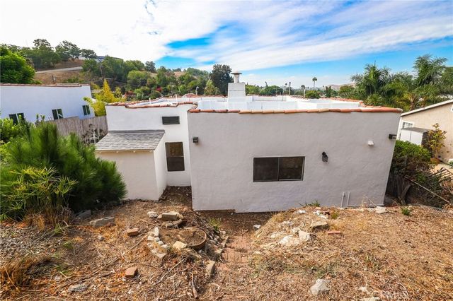 an aerial view of residential houses with outdoor space and trees