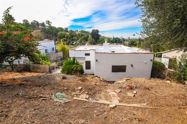 an aerial view of a house with a yard and garden