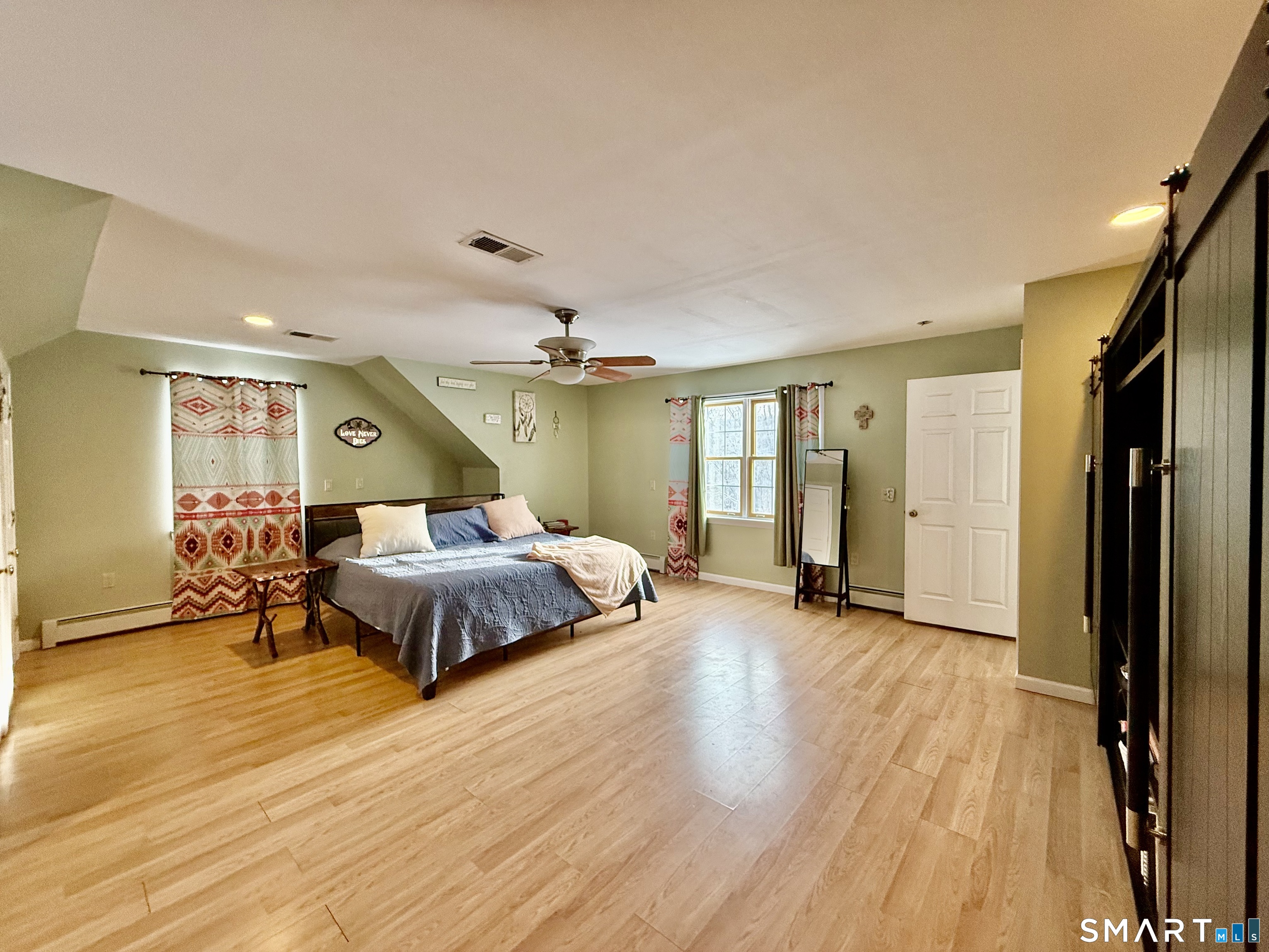 1425 Exeter Road Lebanon, CT 06249 - Photo 11 of 28 a spacious bedroom with a bed and wooden floor