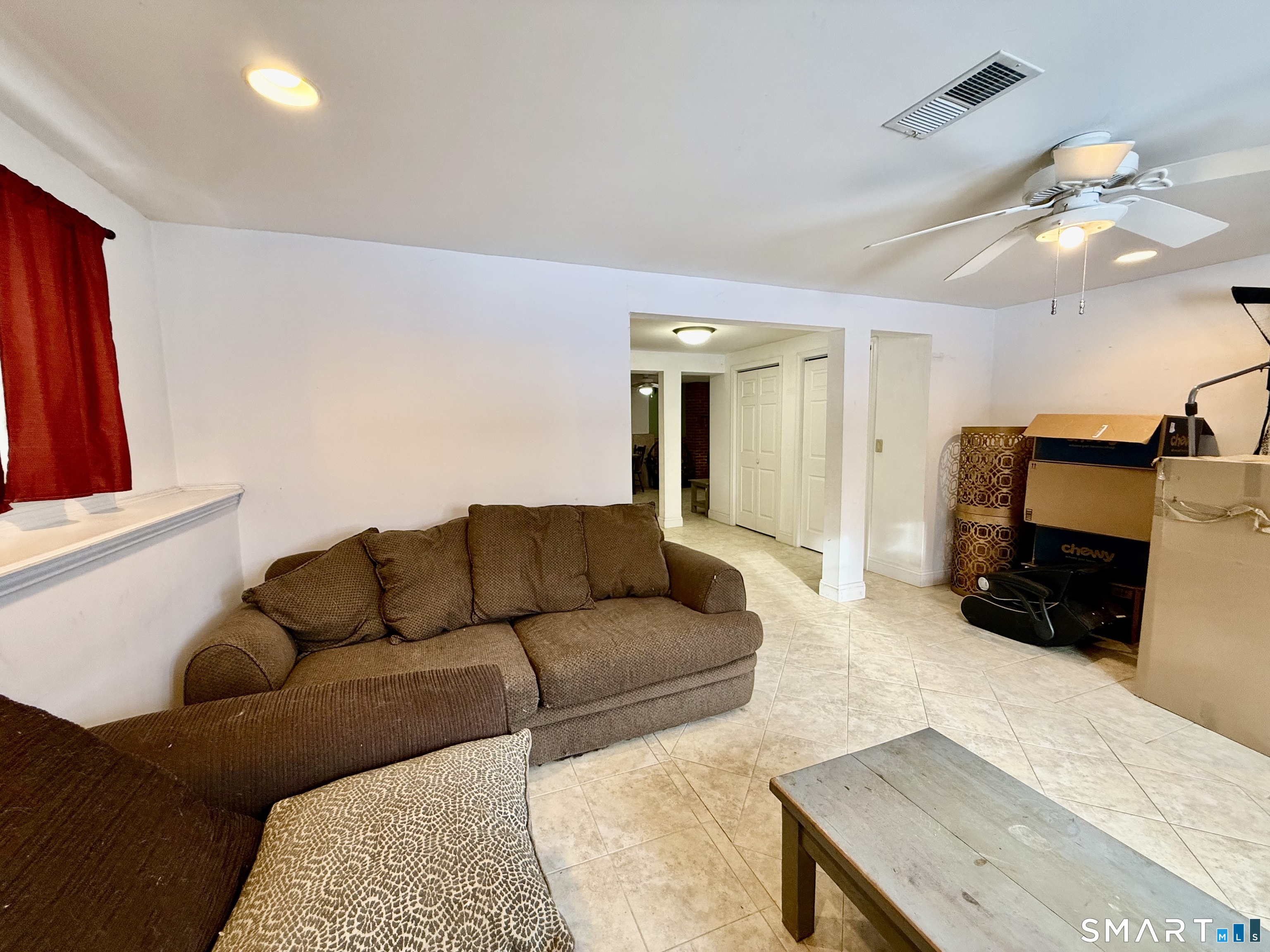 1425 Exeter Road Lebanon, CT 06249 - Photo 20 of 28 a living room with furniture a mirror and a flat screen tv