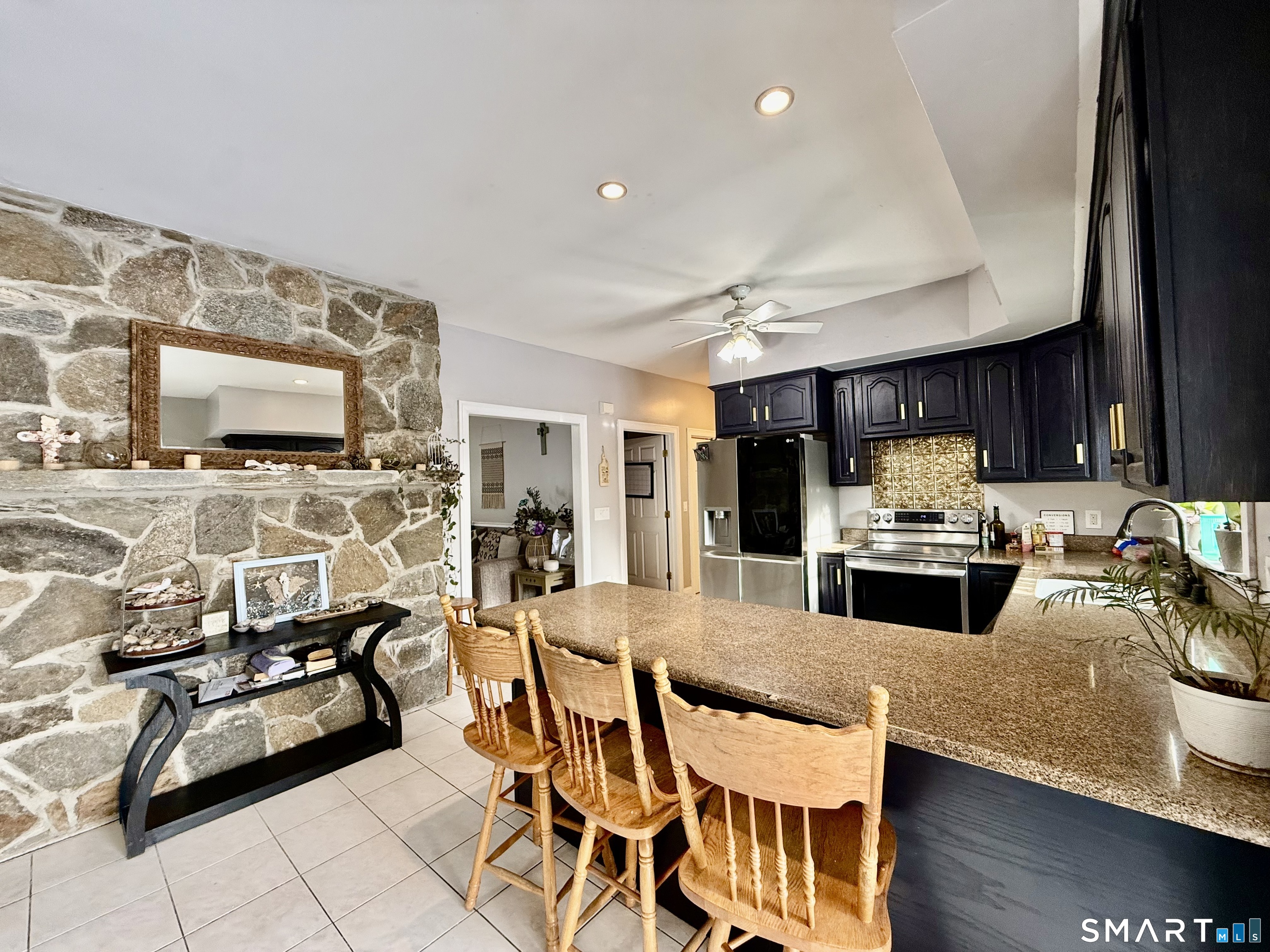 1425 Exeter Road Lebanon, CT 06249 - Photo 6 of 28 a kitchen with stainless steel appliances kitchen island granite countertop a stove and a sink