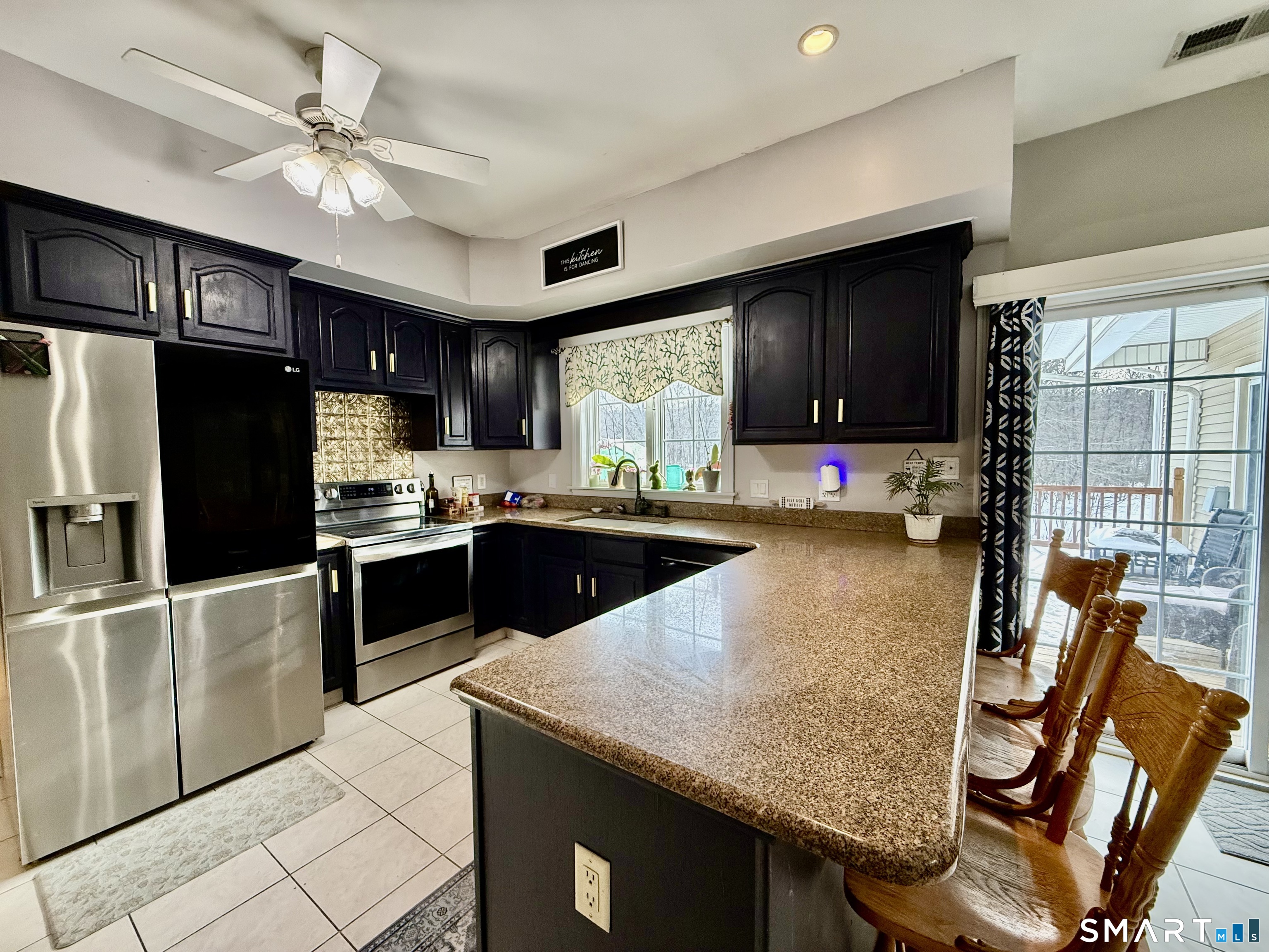 1425 Exeter Road Lebanon, CT 06249 - Photo 7 of 28 a kitchen with granite countertop a sink a counter top space appliances and cabinets