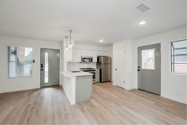 a view of a kitchen cabinets and wooden floor