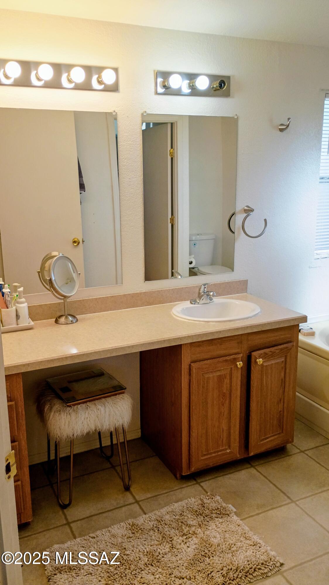 1449 West Hualpai Road Tucson, AZ 85745 - Photo 34 of 49 a bathroom with a sink and a mirror