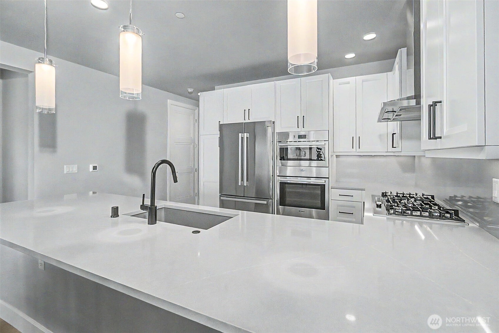 4907 Main Street, Unit 608 Tacoma, WA 98407 - Photo 15 of 40 a kitchen with stainless steel appliances a sink and a refrigerator
