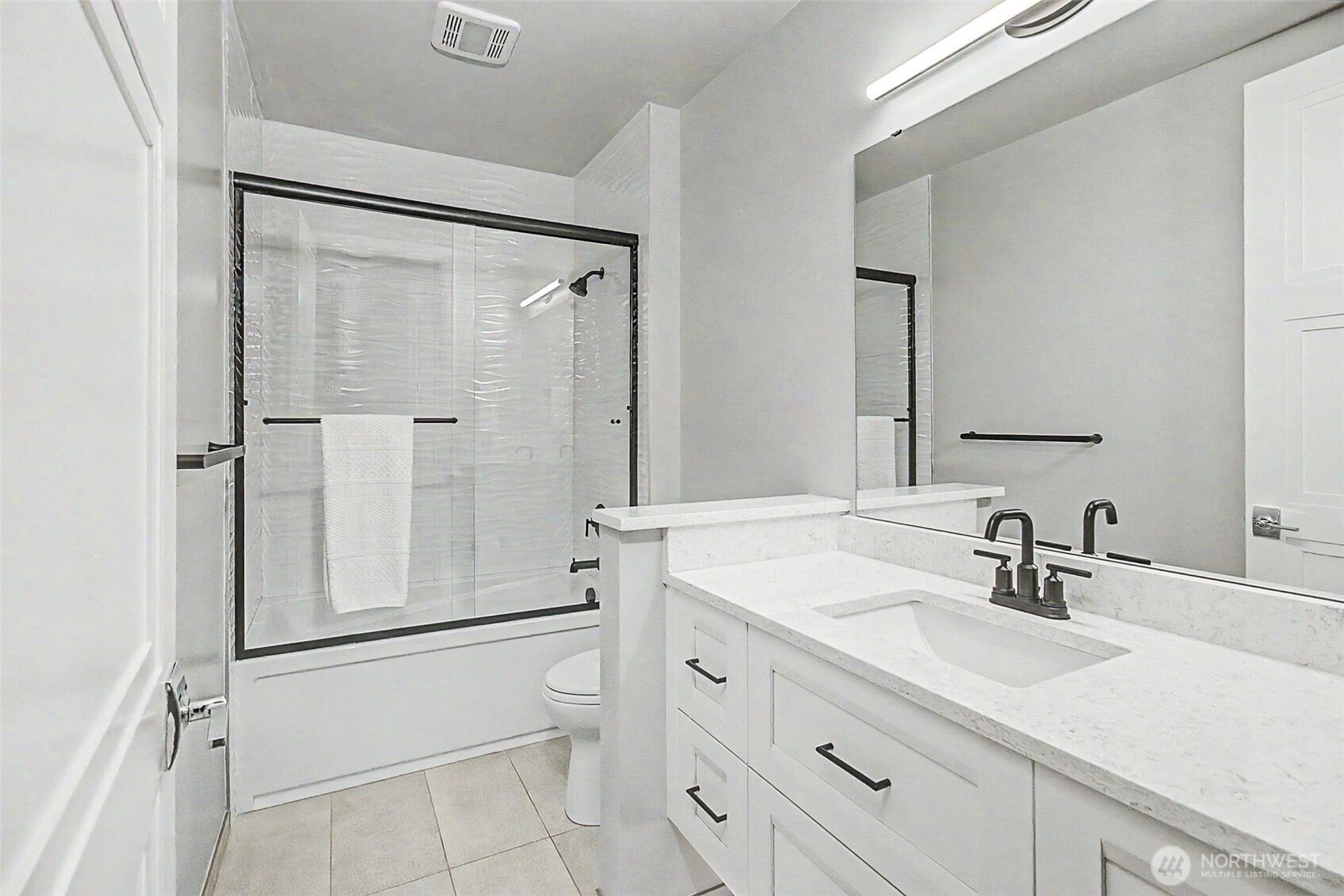 4907 Main Street, Unit 608 Tacoma, WA 98407 - Photo 20 of 40 a bathroom with a shower sink vanity mirror and toilet