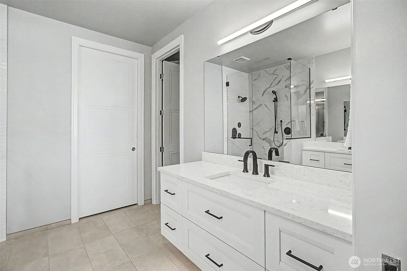 4907 Main Street, Unit 608 Tacoma, WA 98407 - Photo 23 of 40 a bathroom with a sink vanity and a mirror