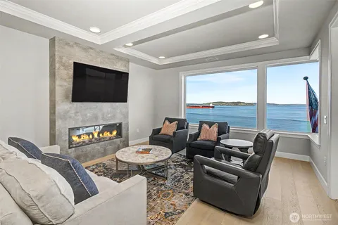 a living room with furniture a flat screen tv and a fireplace