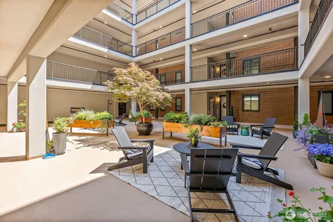 a view of a patio with dining table and chairs