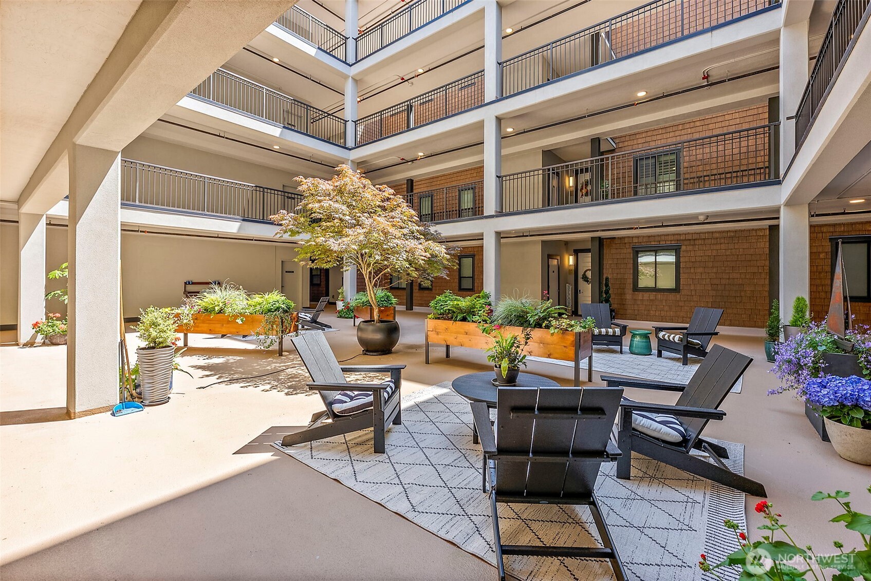 4907 Main Street, Unit 608 Tacoma, WA 98407 - Photo 33 of 40 a view of a patio with couches table and chairs potted plants