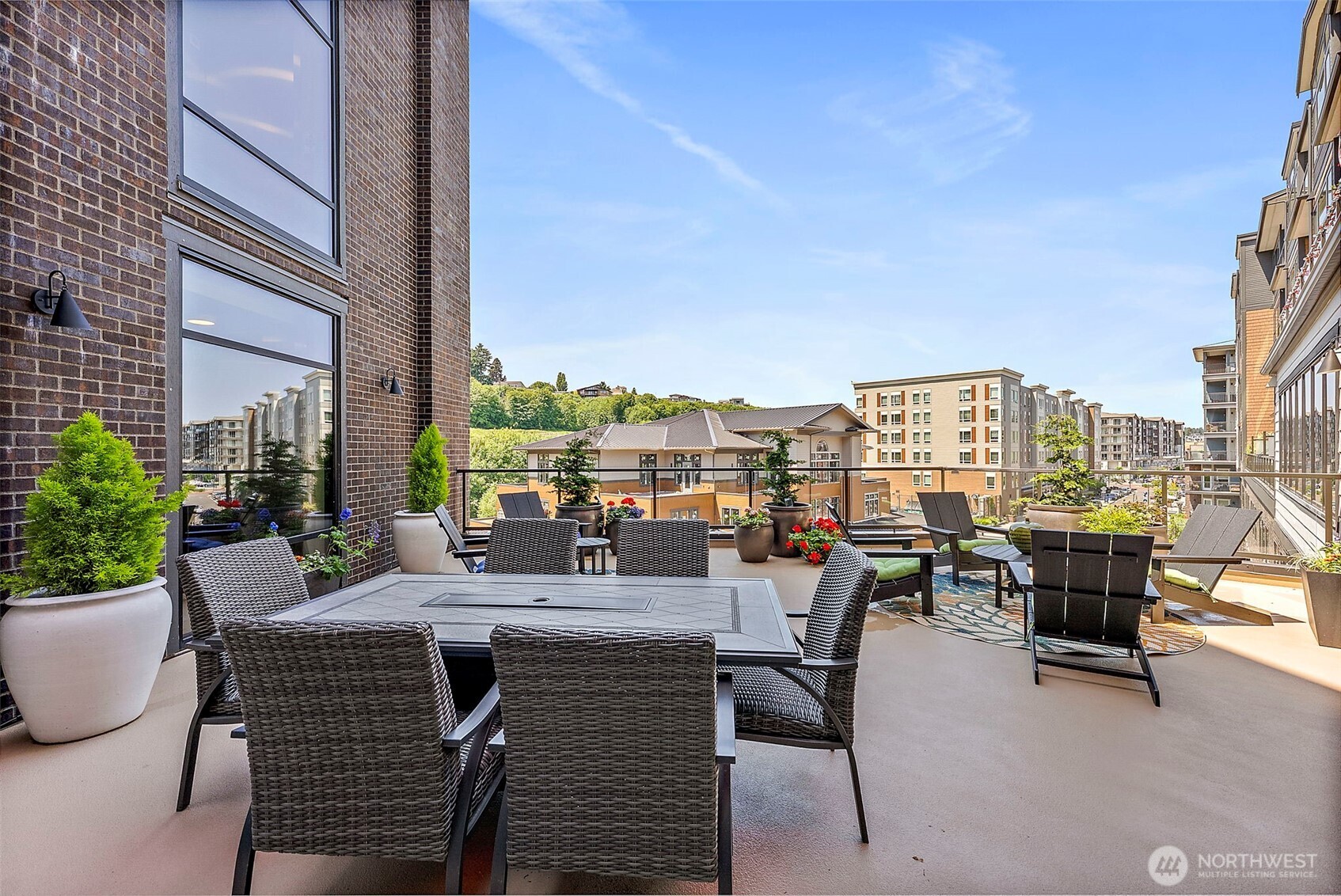 4907 Main Street, Unit 608 Tacoma, WA 98407 - Photo 34 of 40 a view of a patio with dining table and chairs