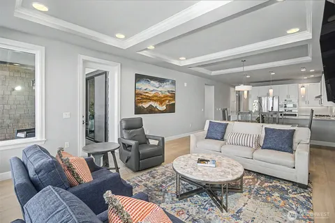 a living room with furniture and a large mirror
