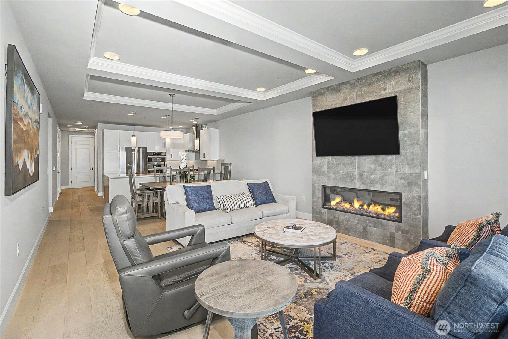 4907 Main Street, Unit 608 Tacoma, WA 98407 - Photo 7 of 40 a living room with furniture a flat screen tv and a fireplace