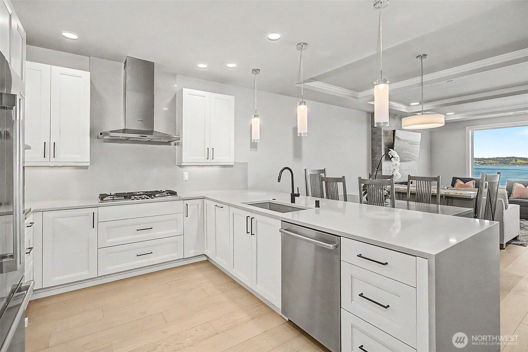 4907 Main Street, Unit 608 Tacoma, WA 98407 - Photo 8 of 40 a kitchen with kitchen island white cabinets and white appliances