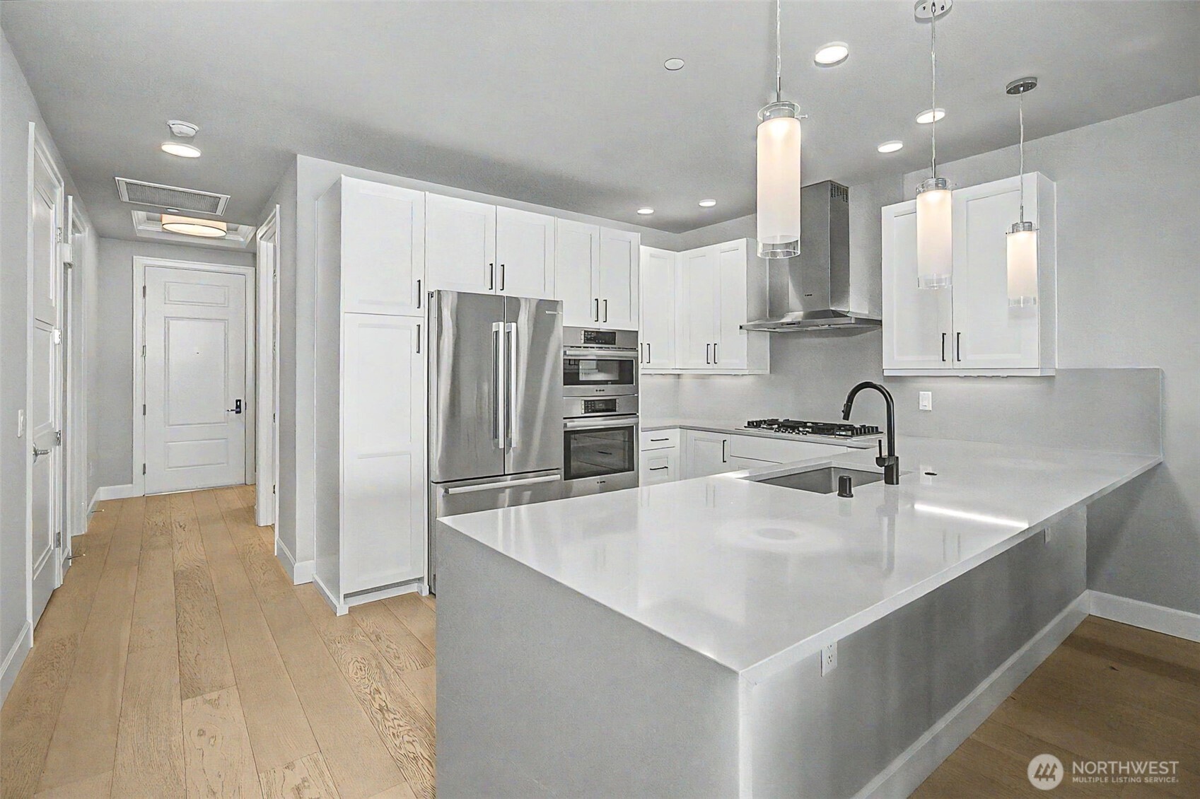 4907 Main Street, Unit 608 Tacoma, WA 98407 - Photo 10 of 40 a large kitchen with stainless steel appliances a refrigerator and a sink