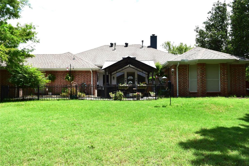 4201 Glistening Spring Rowlett, TX 75088 - Photo 31 of 33 Expansive grassy yard area with a brick exterior home
