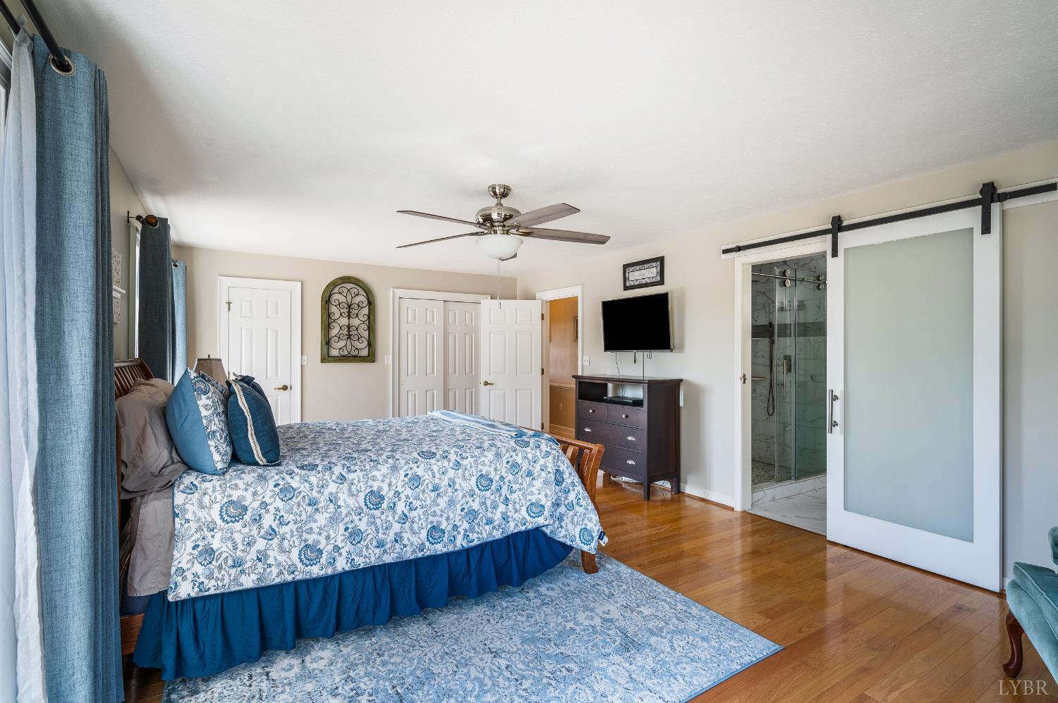 355 Dyson Road Amherst, VA 24521 - Photo 24 of 96 a living room with a bed furniture and a flat screen tv