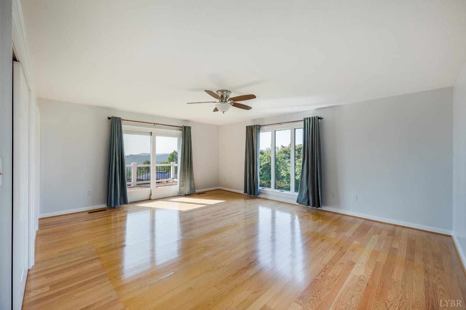355 Dyson Road Amherst, VA 24521 - Photo 44 of 96 a view of an empty room with wooden floor and a window