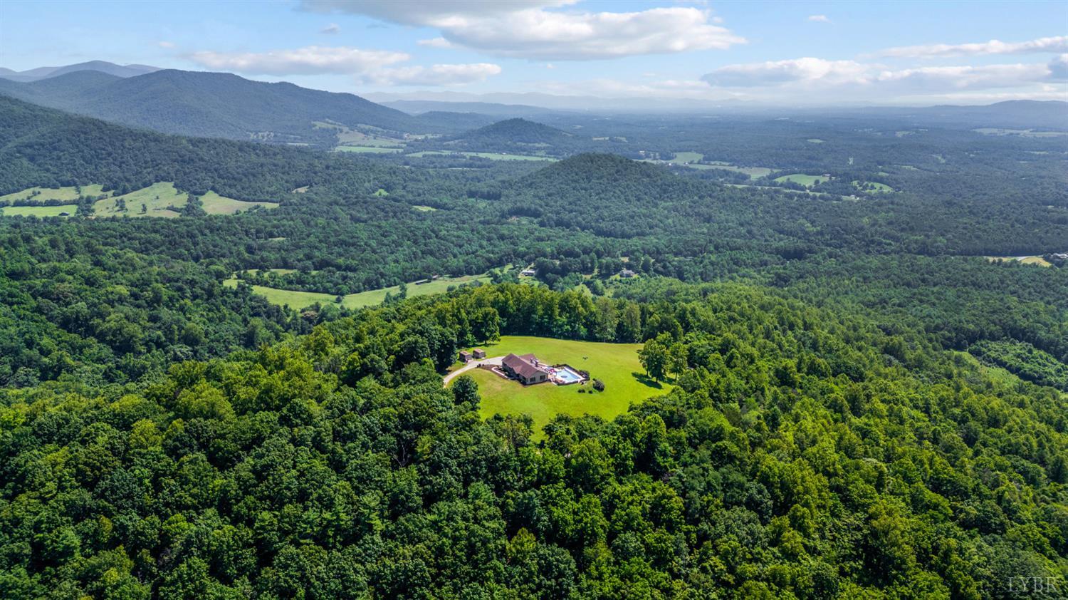 355 Dyson Road Amherst, VA 24521 - Photo 71 of 96 a view of a lush green hillside and a building