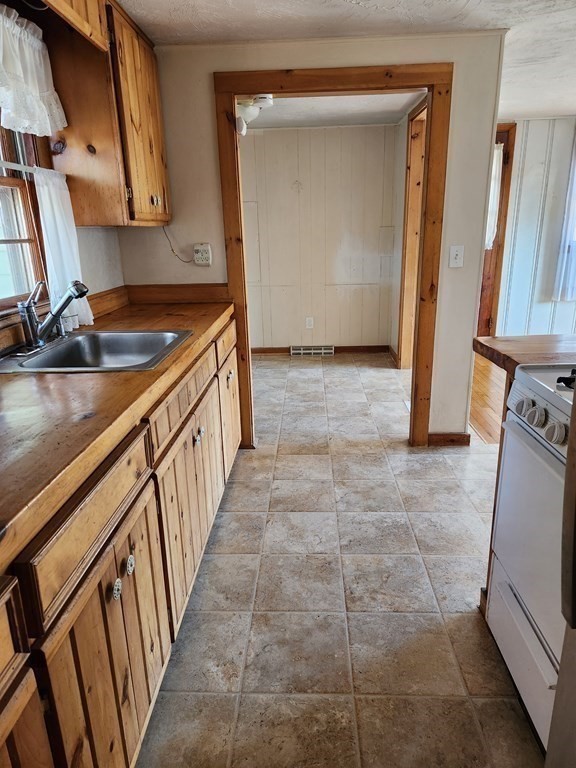 67 Ryder Street Buzzards Bay, MA 02532 - Photo 7 of 14 a view of a kitchen with a sink and a stove top oven