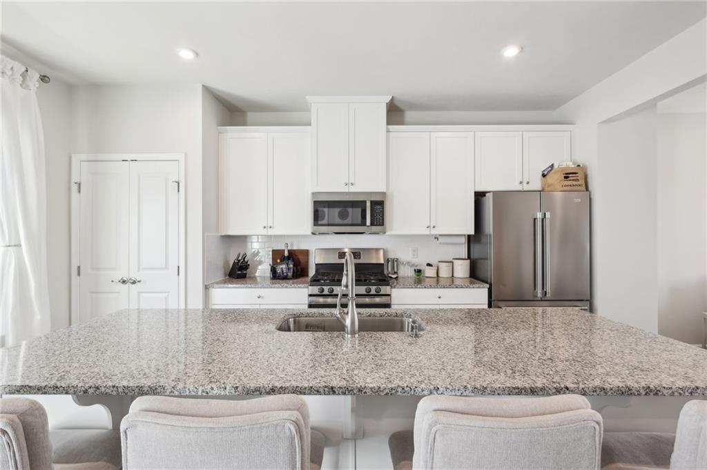 4300 Spruce Road Gibsonia, PA 15044 - Photo 25 of 48 a kitchen with stainless steel appliances granite countertop a sink a stove a microwave a refrigerator and cabinets