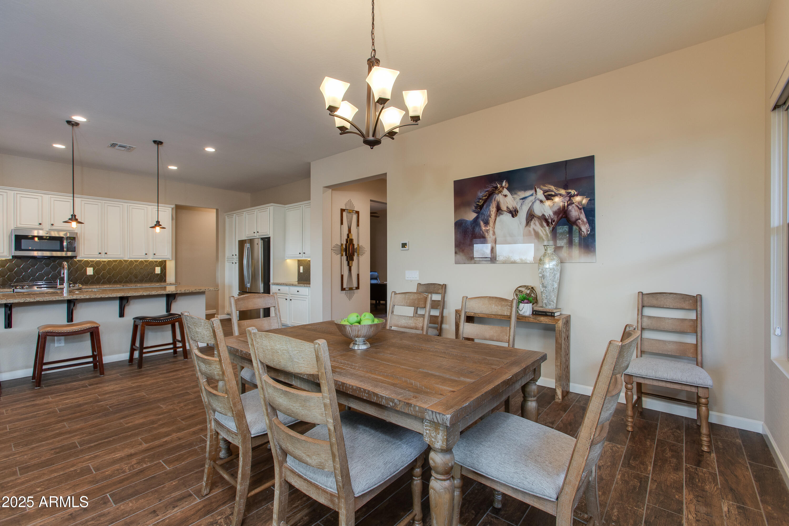 3675 Gold Ridge Road Wickenburg, AZ 85390 - Photo 26 of 66 a view of a dining room with furniture and wooden floor
