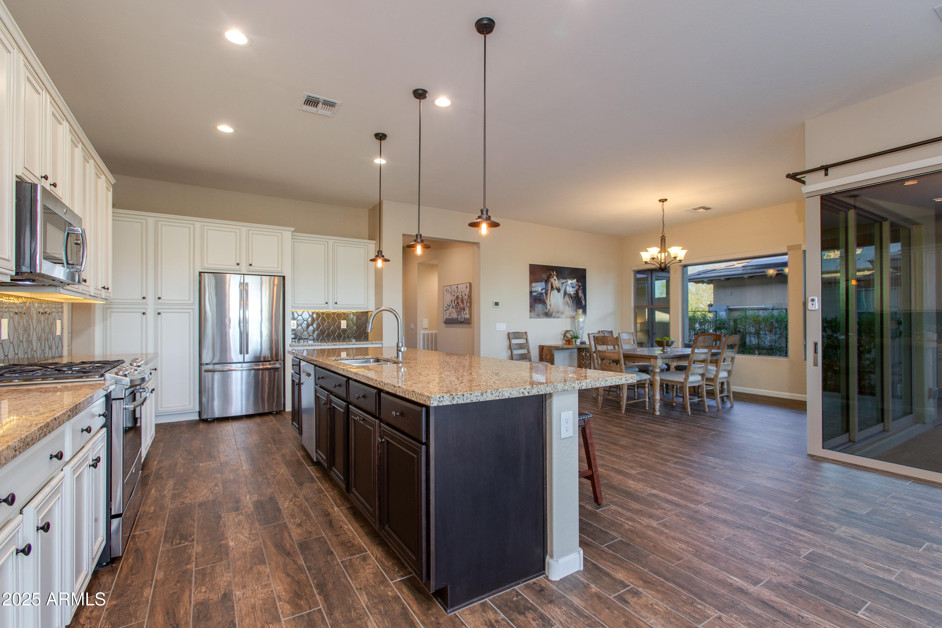 3675 Gold Ridge Road Wickenburg, AZ 85390 - Photo 30 of 66 a kitchen with lots of counter top space and wooden floor
