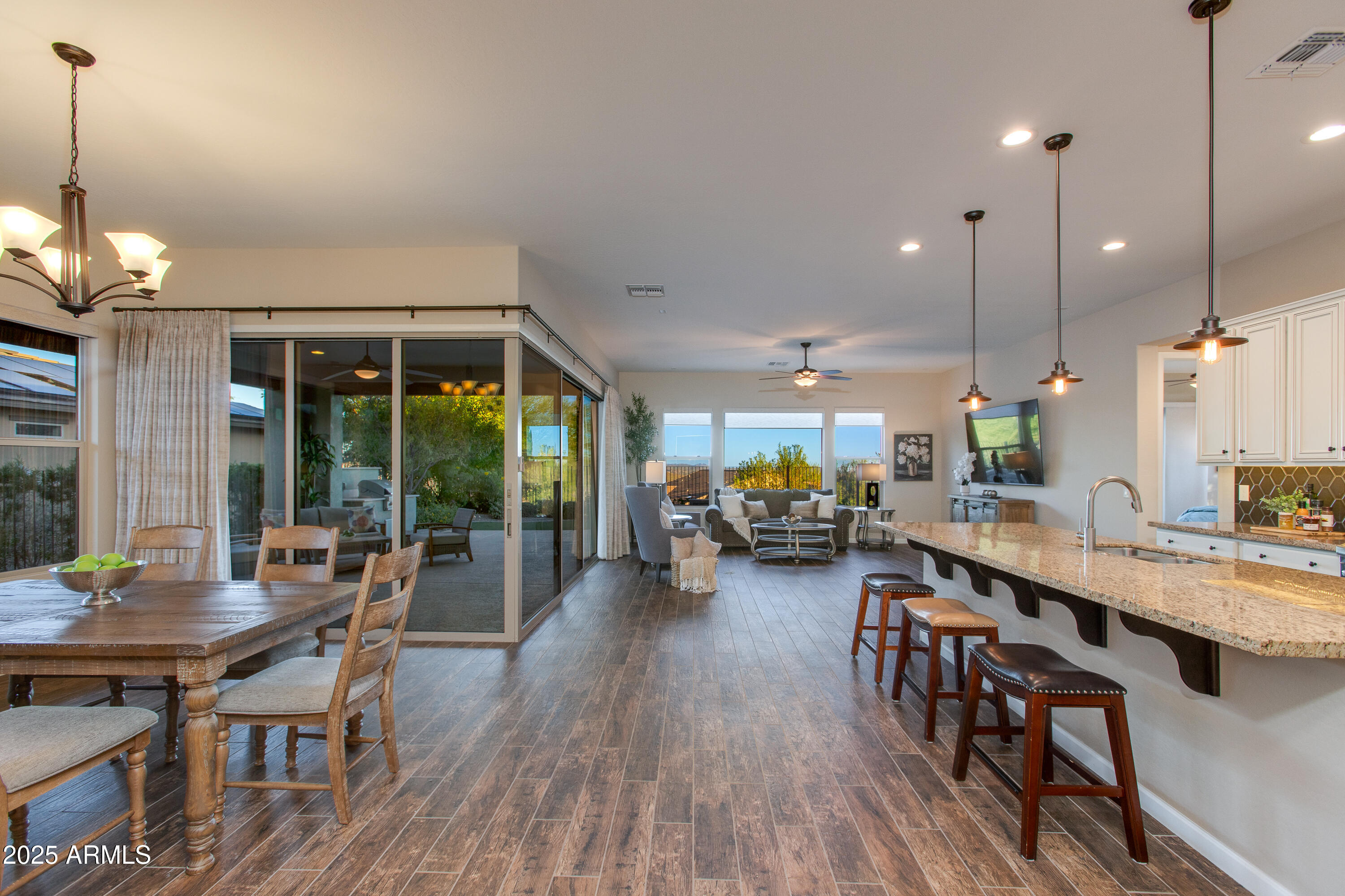 3675 Gold Ridge Road Wickenburg, AZ 85390 - Photo 3 of 66 a view of a dining room and livingroom with furniture wooden floor a chandelier