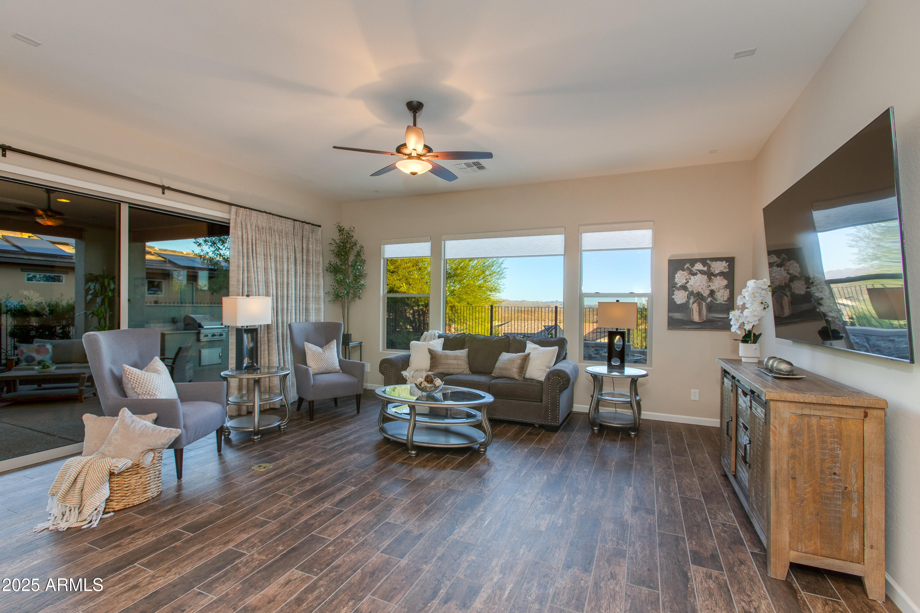 3675 Gold Ridge Road Wickenburg, AZ 85390 - Photo 33 of 66 a living room with furniture dining table a flat screen tv and a large window
