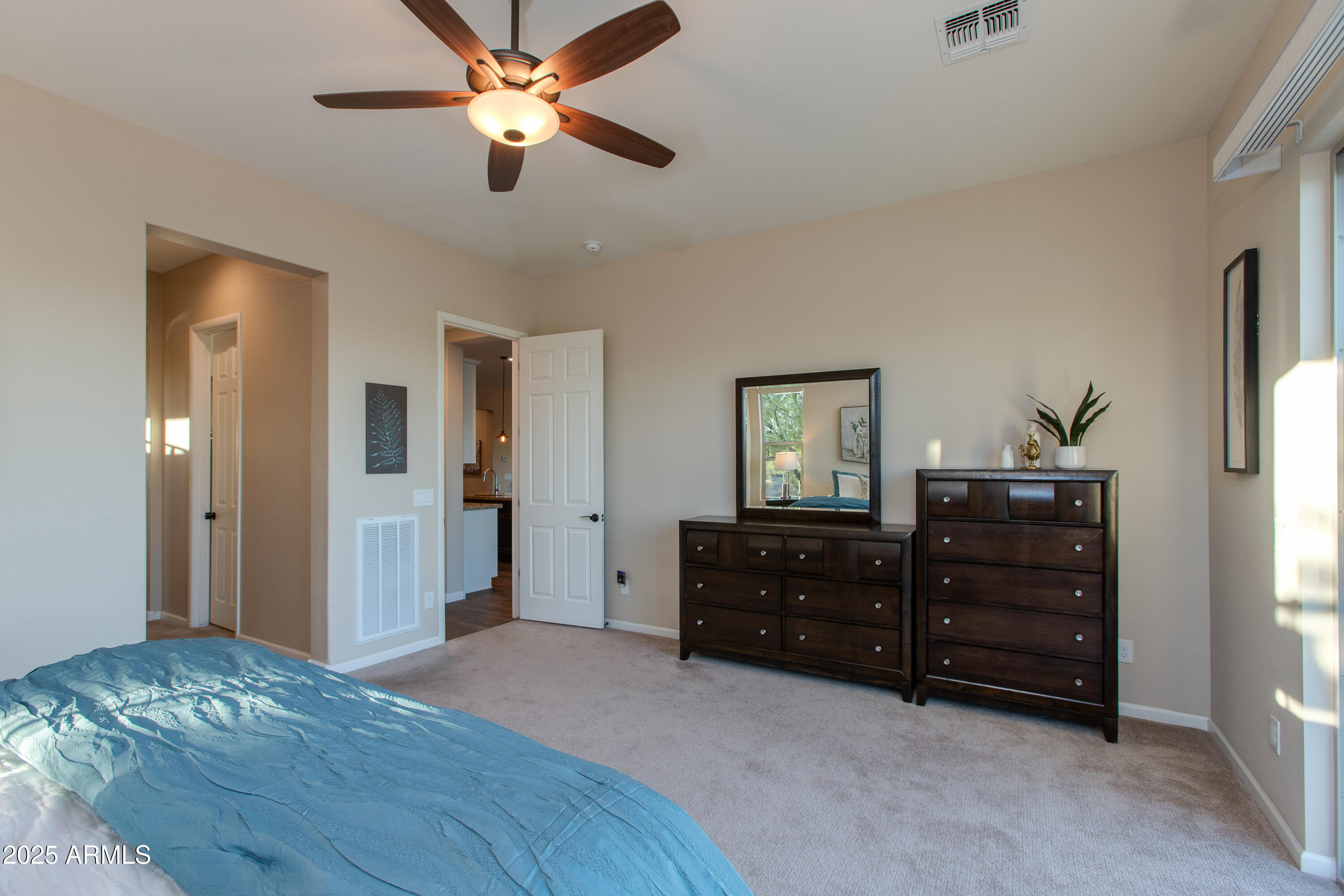 3675 Gold Ridge Road Wickenburg, AZ 85390 - Photo 36 of 66 a bedroom with a bed and a dresser