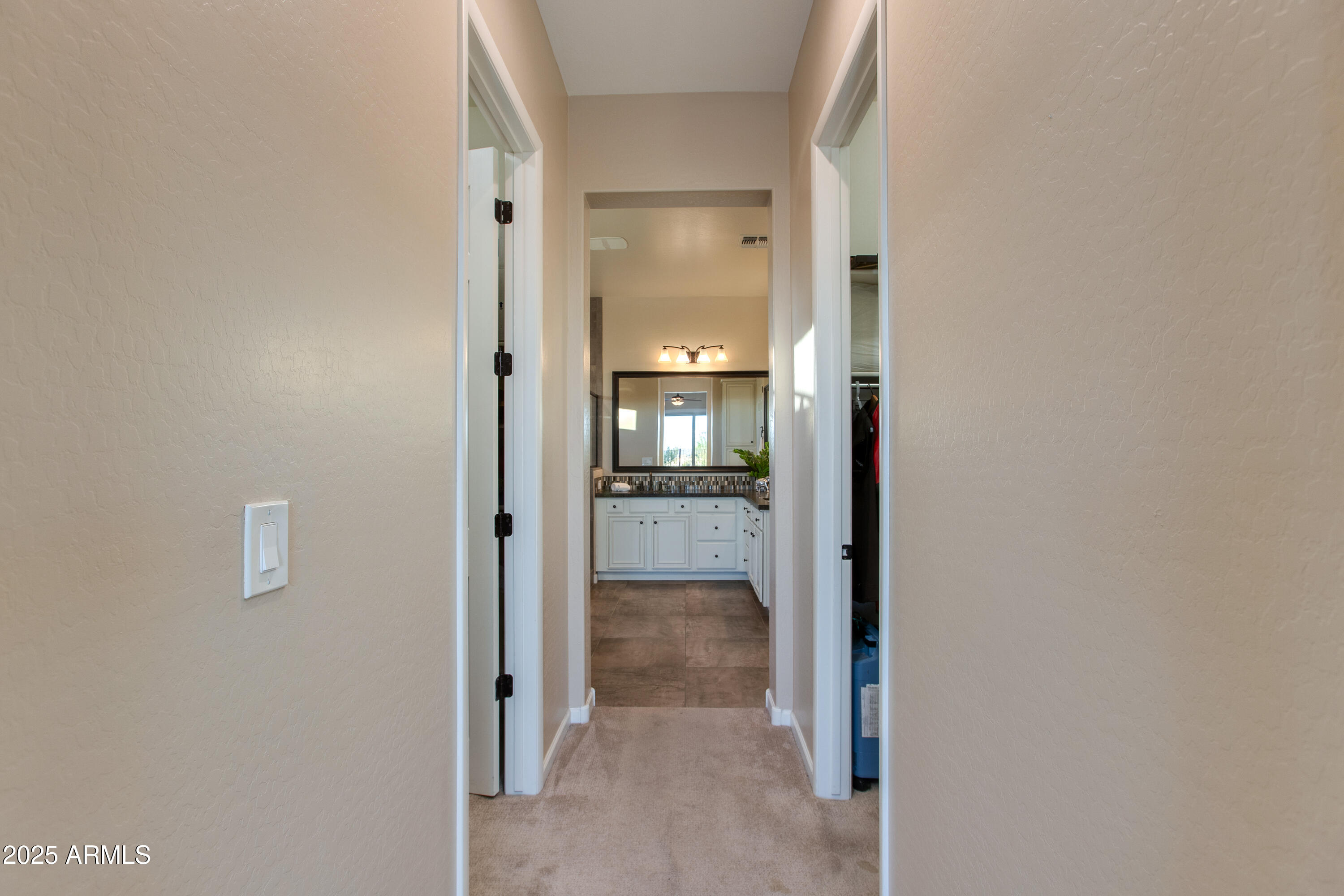 3675 Gold Ridge Road Wickenburg, AZ 85390 - Photo 37 of 66 a view of a hallway with wooden floor and a bathroom