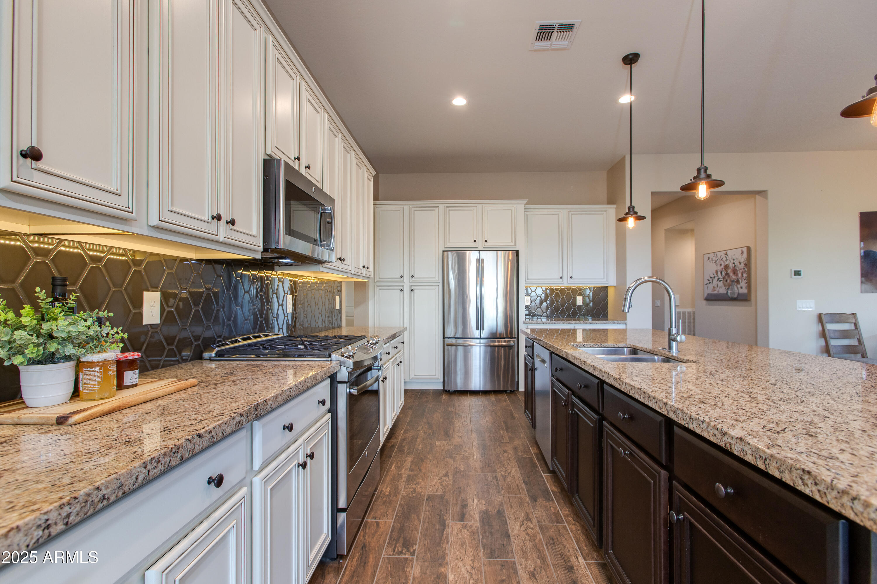 3675 Gold Ridge Road Wickenburg, AZ 85390 - Photo 4 of 66 a kitchen with stainless steel appliances granite countertop a sink a stove and a wooden floors