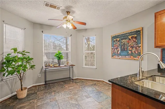 a living room with furniture potted plant and a chandelier