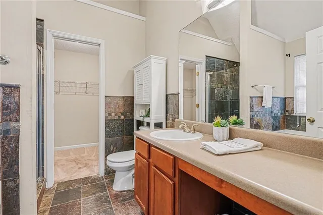 a spacious bathroom with a sink a toilet and shower