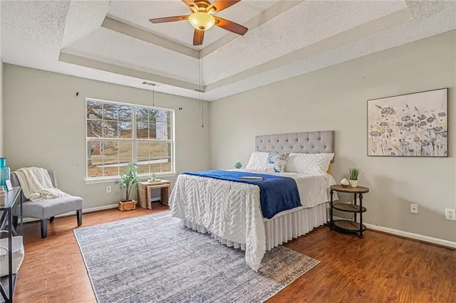 a bedroom with a bed and a chandelier
