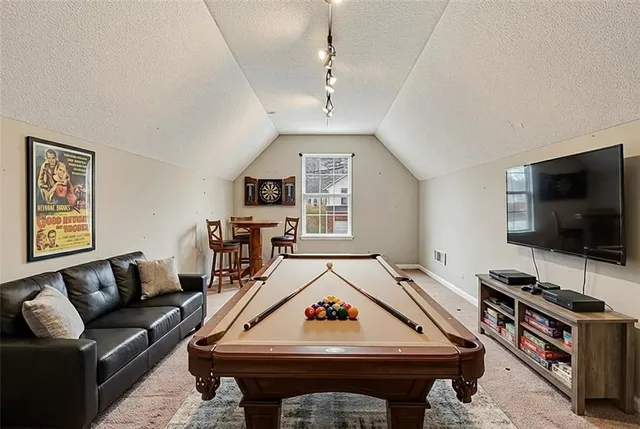 a living room with a flat screen tv and a couch