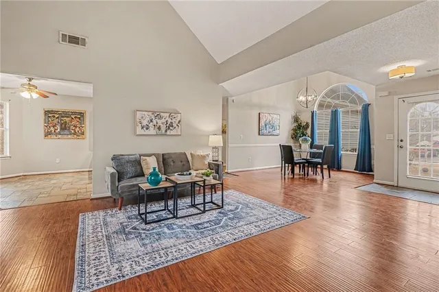 a living room with furniture and wooden floor