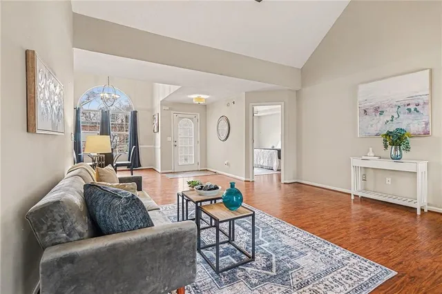 a living room with furniture and wooden floor