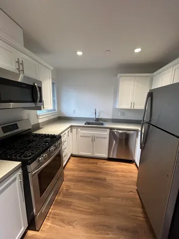 a kitchen with a stove a sink and a refrigerator