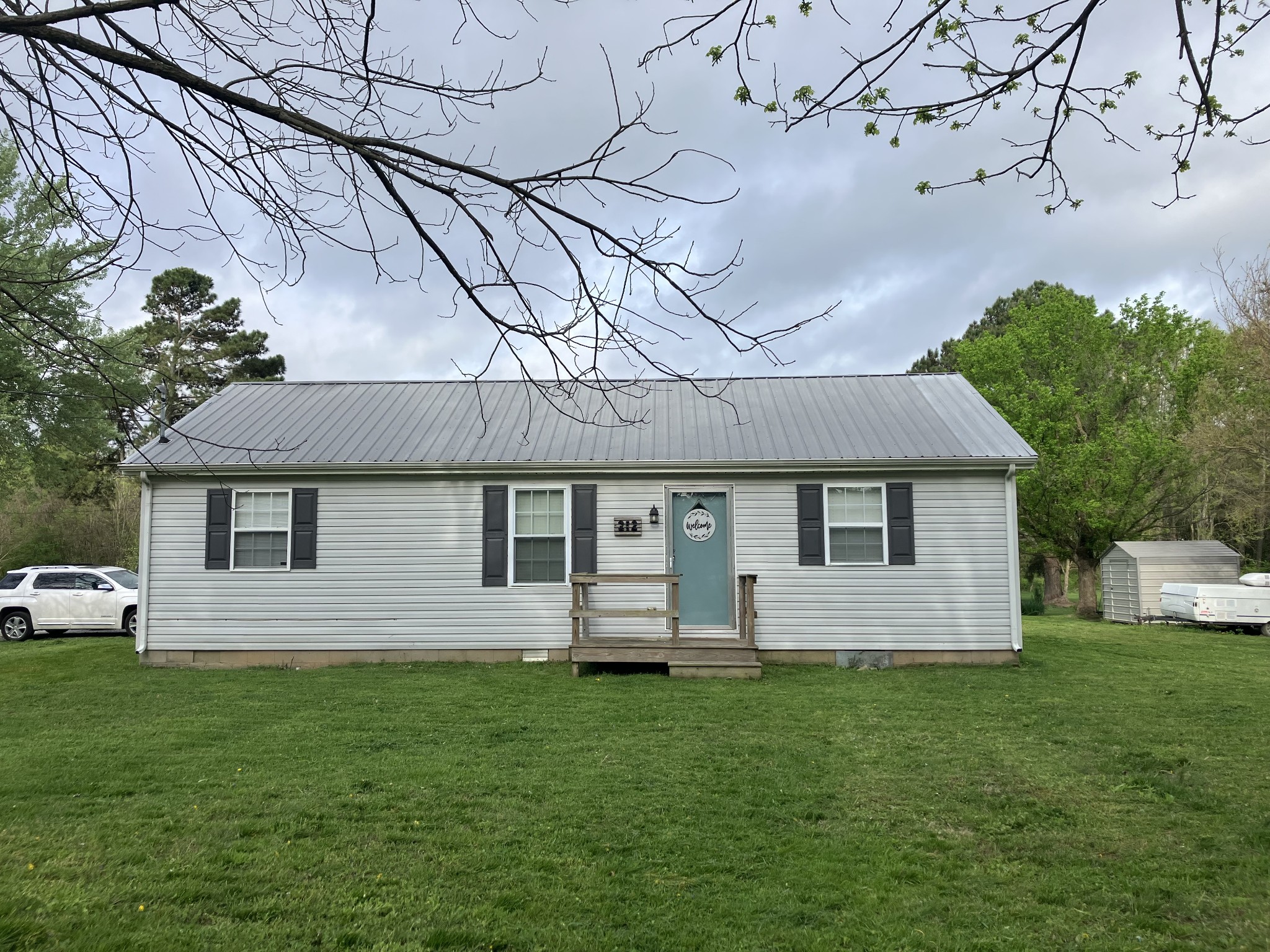 212 Cherry Street Ethridge, TN 38456 - Photo 1 of 12 a front view of a house with a garden