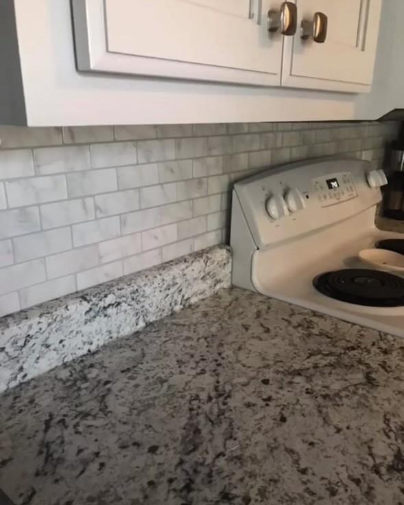 212 Cherry Street Ethridge, TN 38456 - Photo 4 of 12 a bathroom with a sink and a stove