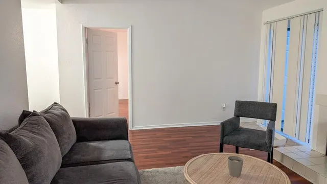 a living room with furniture and a chair