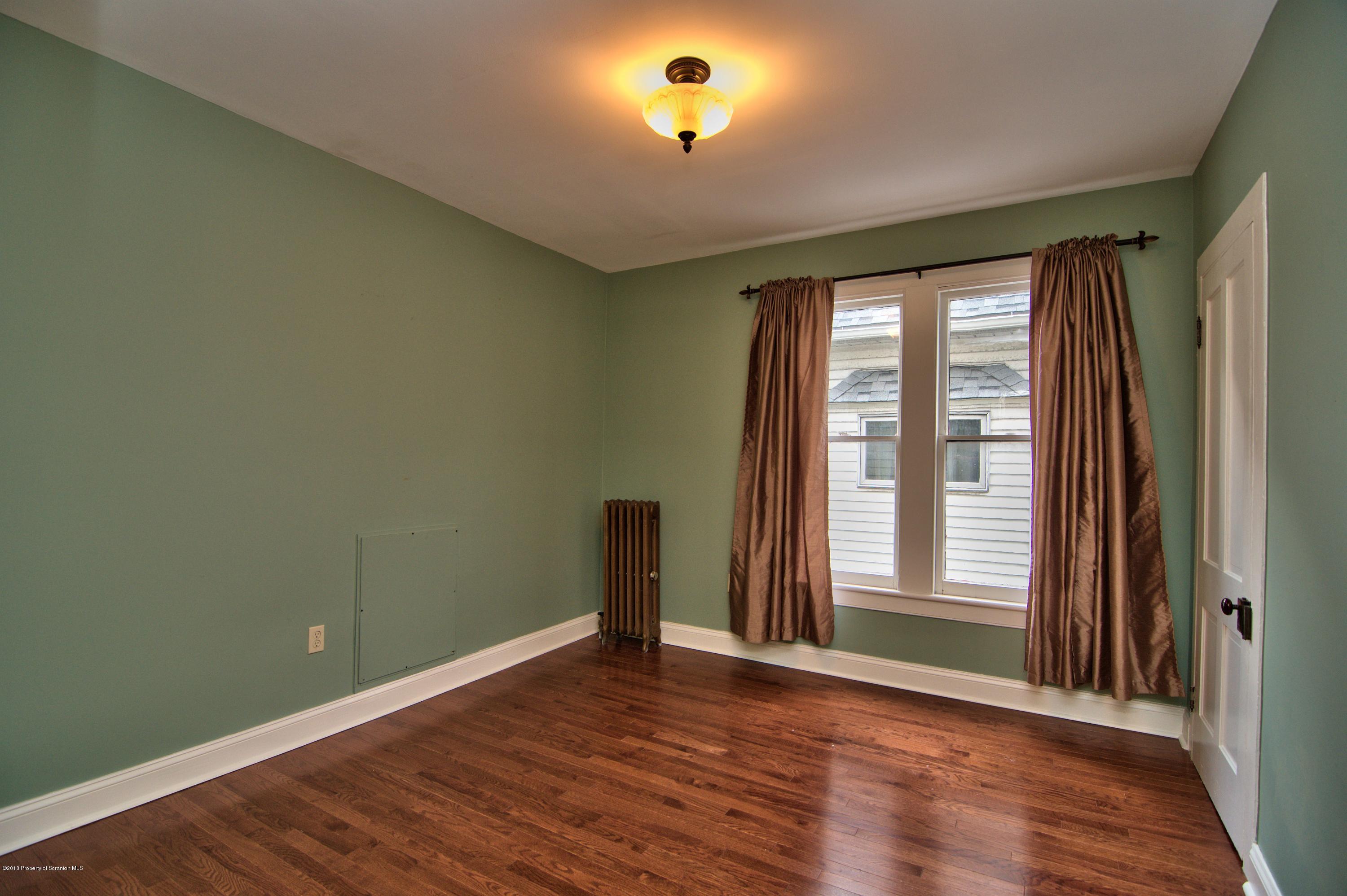 754 Green Ridge Street Scranton, PA 18509 - Photo 14 of 77 a view of an empty room with wooden floor and a window