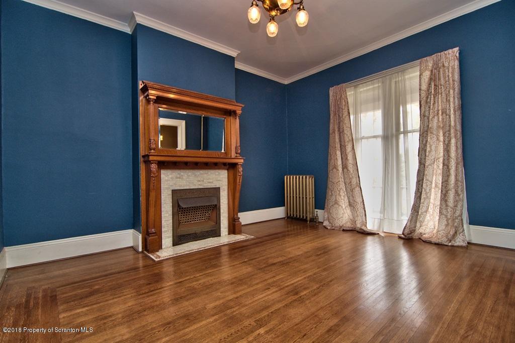 754 Green Ridge Street Scranton, PA 18509 - Photo 30 of 77 an empty room with wooden floor fireplace and windows