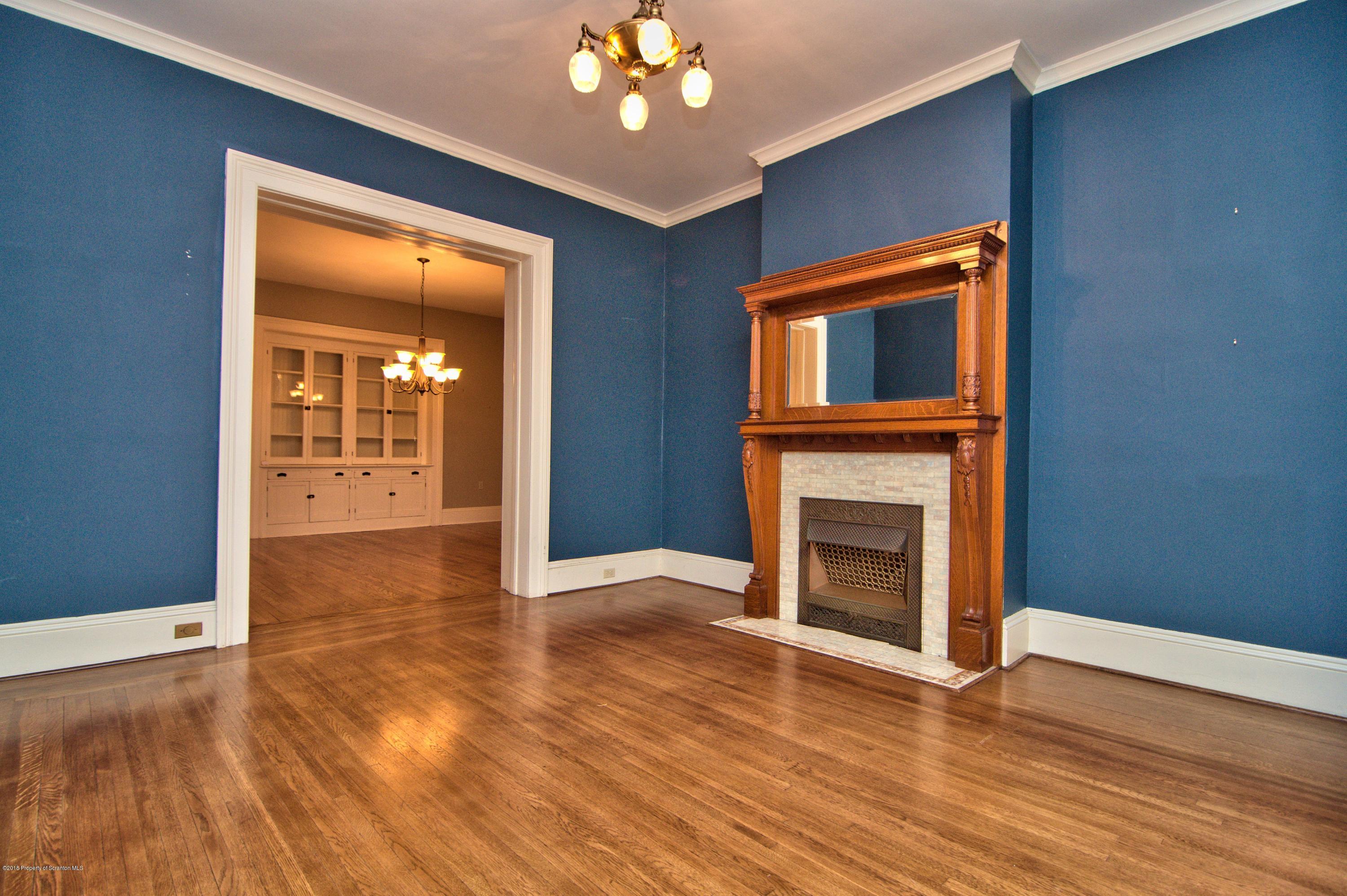 754 Green Ridge Street Scranton, PA 18509 - Photo 3 of 77 a view of an empty room with wooden floor and a fireplace